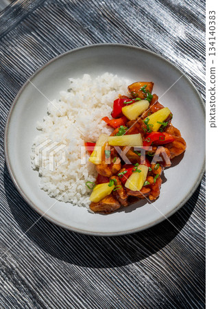 Chicken with pineapple in teriyaki sauce with fried rice.  134140383