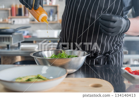 The chef prepares a salad.  134140413
