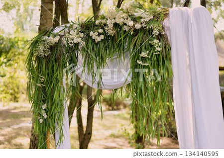 Arch for off-site registration. White chiffon and grass. Outdoor wedding. 134140595