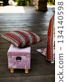 Small pink ottoman chest with pillow. For styling and picnic. On the open veranda 134140598