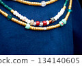 Beads in the old style against the background of blue linen fabric. Vikings, Slavs. Pastiche. 134140605