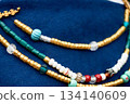 Beads in the old style against the background of blue linen fabric. Vikings, Slavs. Pastiche. 134140609