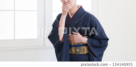 A woman whose kimono obi is tight A woman whose kimono obi is tight 134140955