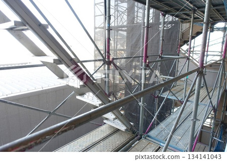 Scaffolding for repair work on the exterior walls of a high-rise apartment building Scaffolding for repair work on the exterior walls of a high-rise apartment building 134141043