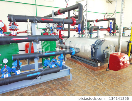 A modern boiler room with two large industrial boilers A modern boiler room with two large industrial boilers 134141266