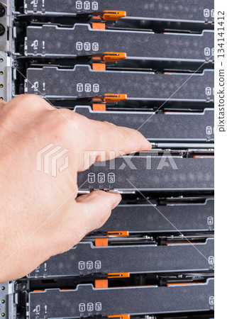 network administrator pulling data storage hardware from sever r 134141412