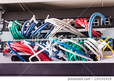 Fiber Optic cables connected to optic ports, network cables conn 134141419