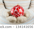 Christmas ball in hands 134141656