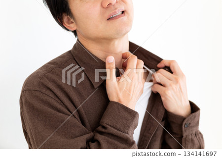 A middle-aged man suffering from dry, itchy skin 134141697