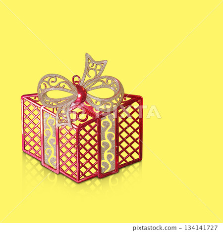 A red plastic gift box is placed on a yellow background, fashion, gift, decor, decoration, object, ancient, antique, copy space 134141727