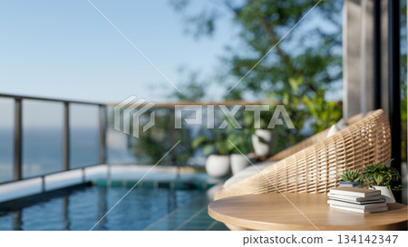 Ratten woven sofa chair and table aside outdoor swimming pool with panoramic view glass partition 134142347