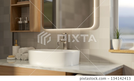 Mirror and wooden shelf on tiles wall over ceramic sink on marble counter with towels in bathroom. 134142413