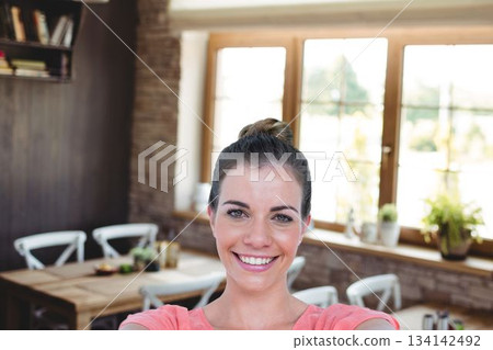 Portrait of happy woman at cafe 134142492