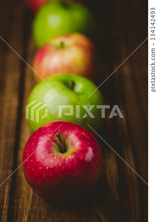 Red and green apples on table 134142493