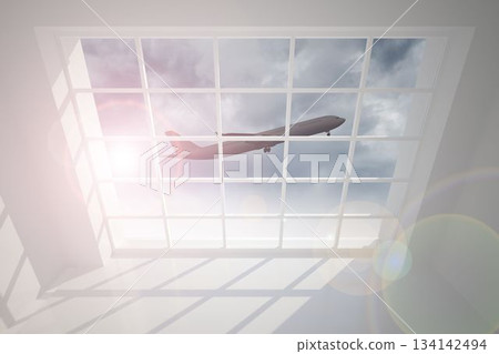 Airplane flying past window 134142494