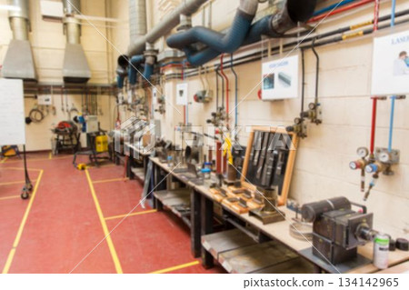 Row of metal workbenches is being shown in flat design workshop, with vices and gauges Row of metal workbenches is being shown in flat design workshop, with vices and gauges 134142965