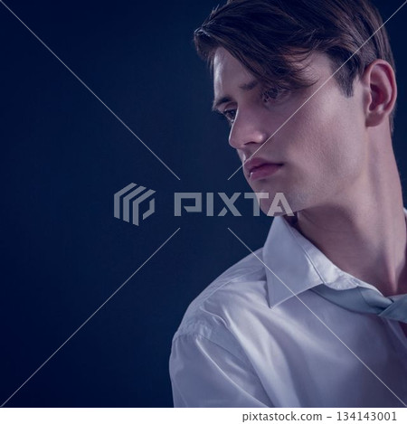 Close up of thoughtful young man looking away Close up of thoughtful young man looking away 134143001