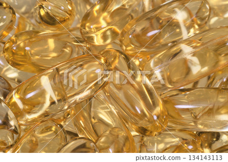 Capsules with fish oil background Capsules with fish oil background 134143113