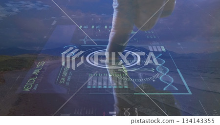 Mid adult man finger pressing medical interface in desert valley, with DNA helix and HUD 134143355