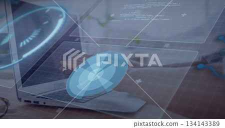 Typing female hands navigating blue holographic interface on silver laptop at home office desk Typing female hands navigating blue holographic interface on silver laptop at home office desk 134143389
