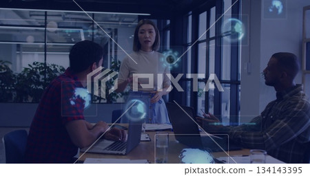 Leading discussion professional woman presenting holographic display in office meeting with laptops Leading discussion professional woman presenting holographic display in office meeting with laptops 134143395