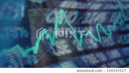 Displaying neon turquoise zigzag line chart on trading monitor, with blurred financial interface 134143527