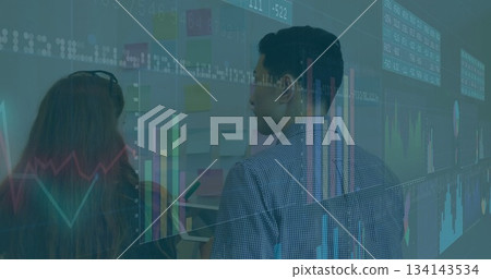 Analyzing whiteboard notes coworkers in business casual attire in conference room, with tablet Analyzing whiteboard notes coworkers in business casual attire in conference room, with tablet 134143534