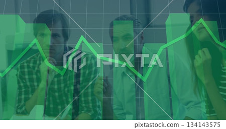 Analyzing business team studying chart overlay with gridlines in boardroom, with pens notebooks 134143575
