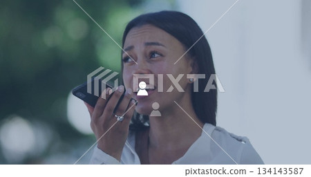 Holding smartphone near mouth, adult woman in white blouse looking concerned on patio, copy space Holding smartphone near mouth, adult woman in white blouse looking concerned on patio, copy space 134143587