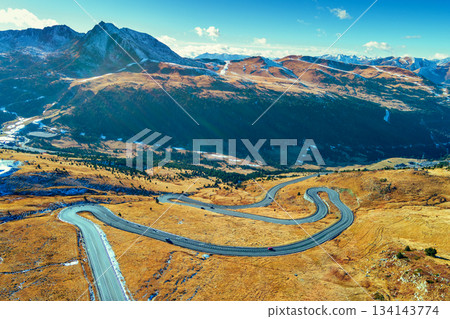 Mountain landscape on a sunny autumn day. View of highway in Pyrenees mountains, Andorra, Europe Mountain landscape on a sunny autumn day. View of highway in Pyrenees mountains, Andorra, Europe 134143774