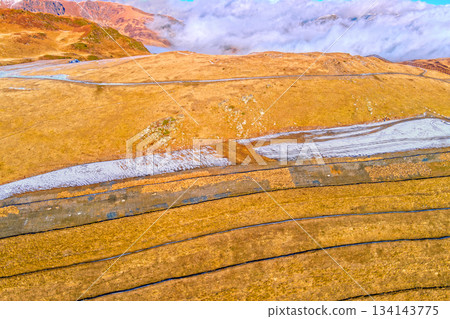 Mountain landscape in autumn. Slopes covered with dry grass. View from above of mountains valley Pyrenees, Andorra, Europe 134143775