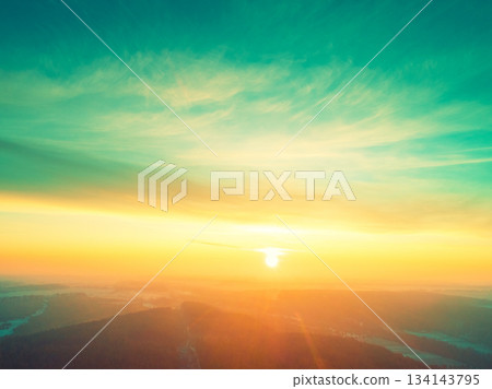 Beautiful dramatic evening sky over pine forest. Village in the forest during sunset. Aerial view Beautiful dramatic evening sky over pine forest. Village in the forest during sunset. Aerial view 134143795