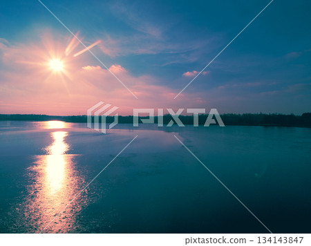 Aerial view of the frozen lake in the evening at sunset light. Beautiful nature landscape 134143847