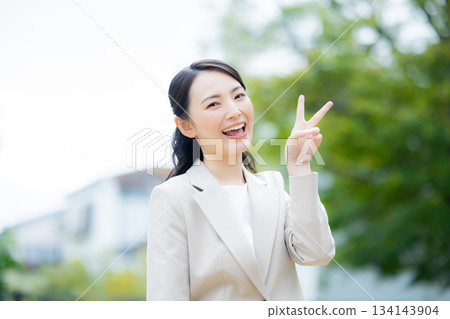 Businesswoman walking in the park 134143904