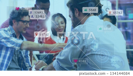 Pointing six professionals analyzing social metrics on tablet in modern office, with icon overlays Pointing six professionals analyzing social metrics on tablet in modern office, with icon overlays 134144084