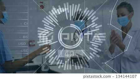 Three masked professionals sanitizing hands in hospital with sanitizer dispenser and stethoscope 134144107