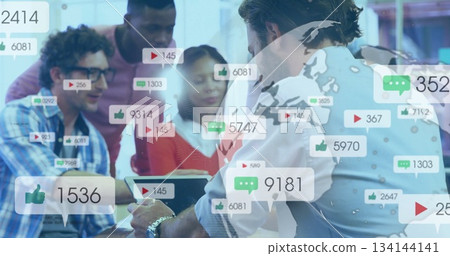 Reviewing six professionals analyzing media metrics overlay on tablet with laptop at office table 134144141