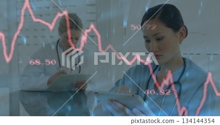 Analyzing live data nurse in scrubs using tablet on glass desk in consultation room, copy space Analyzing live data nurse in scrubs using tablet on glass desk in consultation room, copy space 134144354