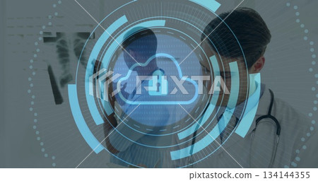 Reviewing chest X-ray film on viewer, doctors examining in clinic with stethoscope, digital overlay Reviewing chest X-ray film on viewer, doctors examining in clinic with stethoscope, digital overlay 134144355