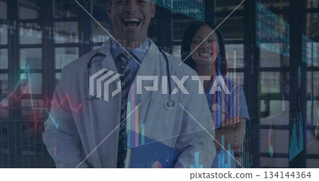 Standing professionals in lab coat, scrubs analyzing floating charts with folder in clinic corridor 134144364