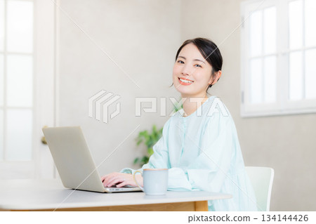 A woman using a computer A woman using a computer 134144426