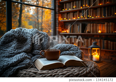 This image captures a cozy reading nook beside a rain-streaked window, perfect for relaxation on a rainy day. 134145172