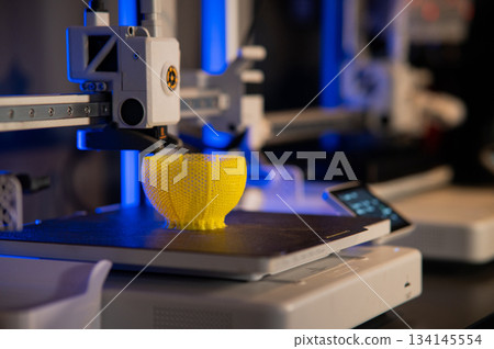 A student man print prototype on 3D printer 134145554