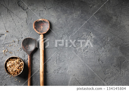 Vintage Wooden Spoons with Crushed Spices on Dark Stone Background Vintage Wooden Spoons with Crushed Spices on Dark Stone Background 134145804