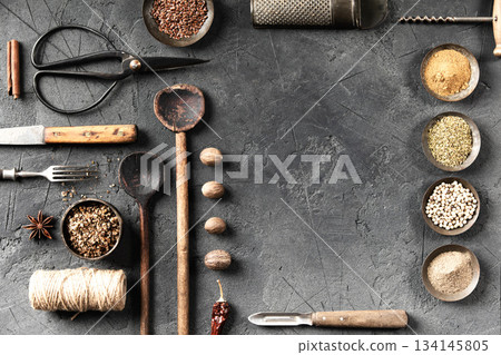 Rustic Culinary Tools and Spices on Dark Stone Background Rustic Culinary Tools and Spices on Dark Stone Background 134145805