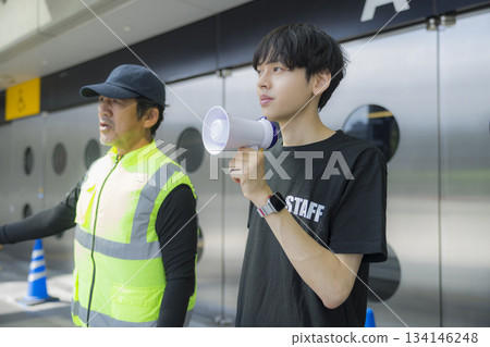 Staff guiding people at the event venue 134146248