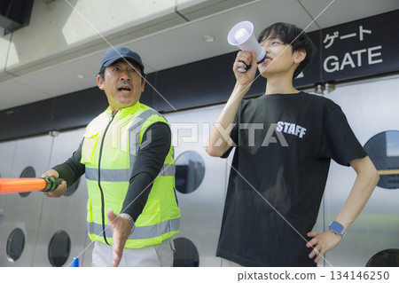 Staff guiding people at the event venue 134146250