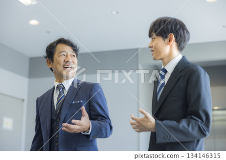 Businessman walking in an office building Businessman walking in an office building 134146315