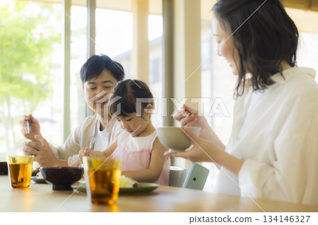 A happy family at the dinner table A happy family at the dinner table 134146327