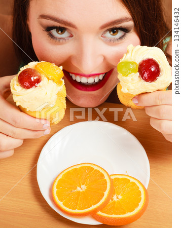 Woman taking delicious sweet cake. Gluttony. 134146432